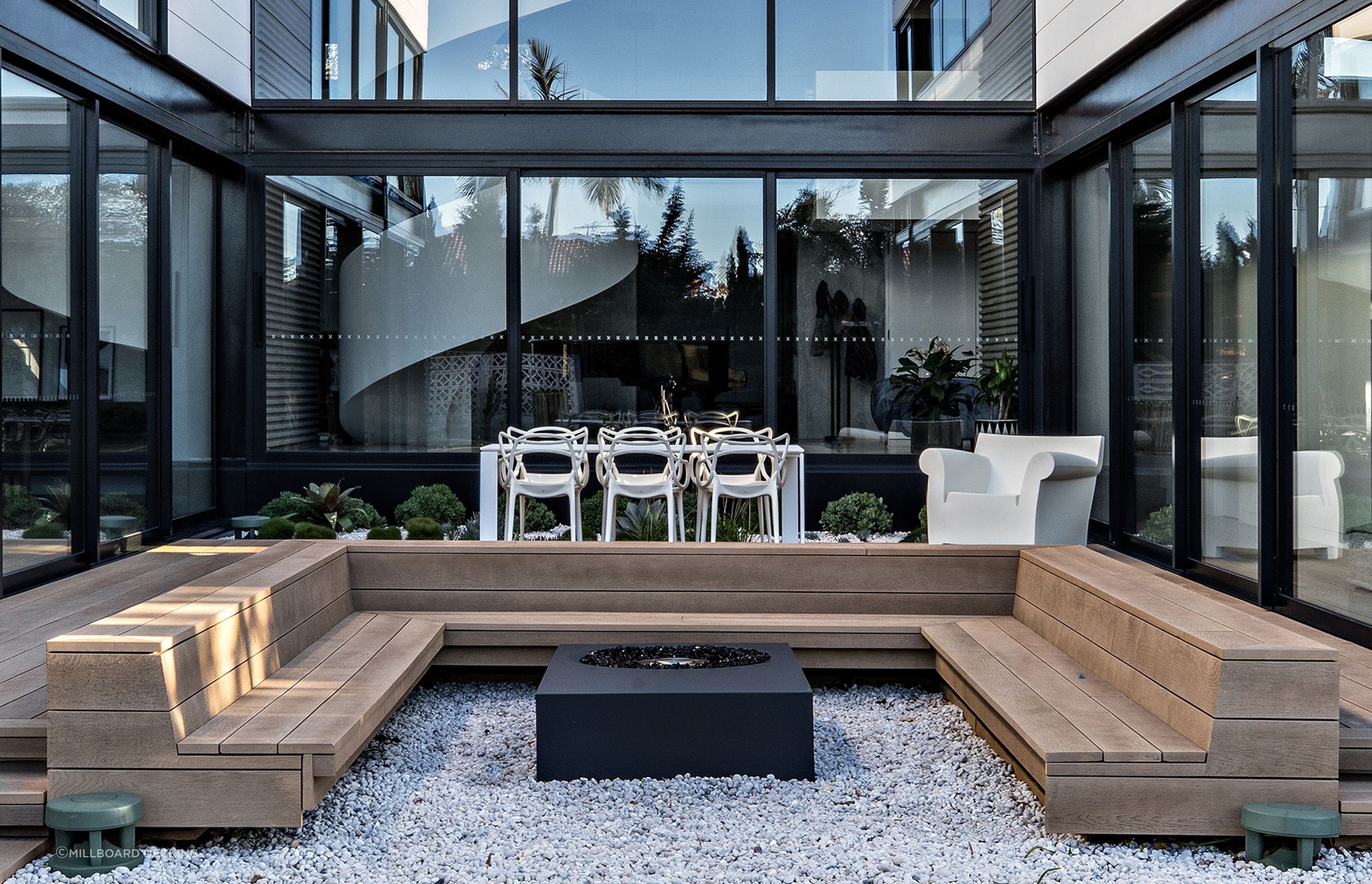 Built-in seating creates a warm entertaining area with Millboard Decking | Photography: The Palm Co. Photography