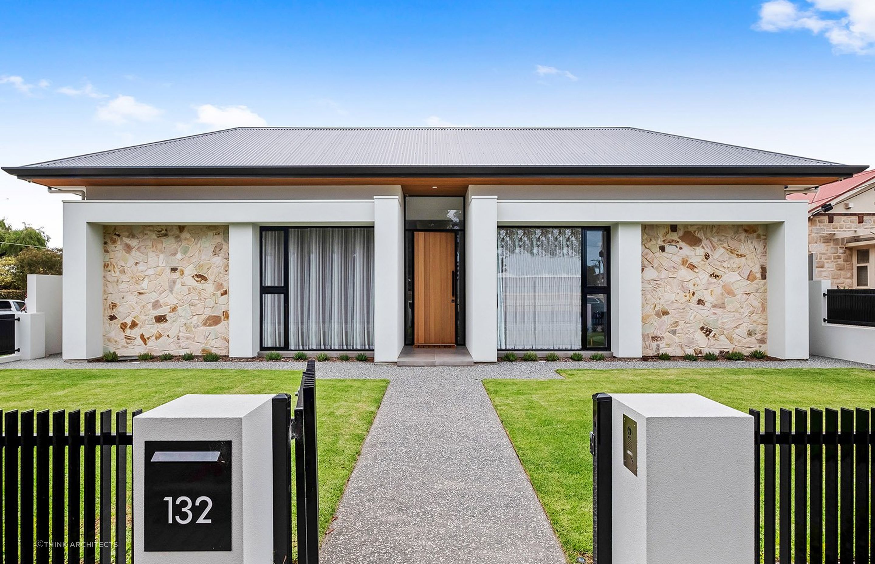 With the front door withdrawn more attention is given to the supporting pillars, windows and stone cladding. Featured project: East Terrace Residence - Henley Beach by Think Architects
