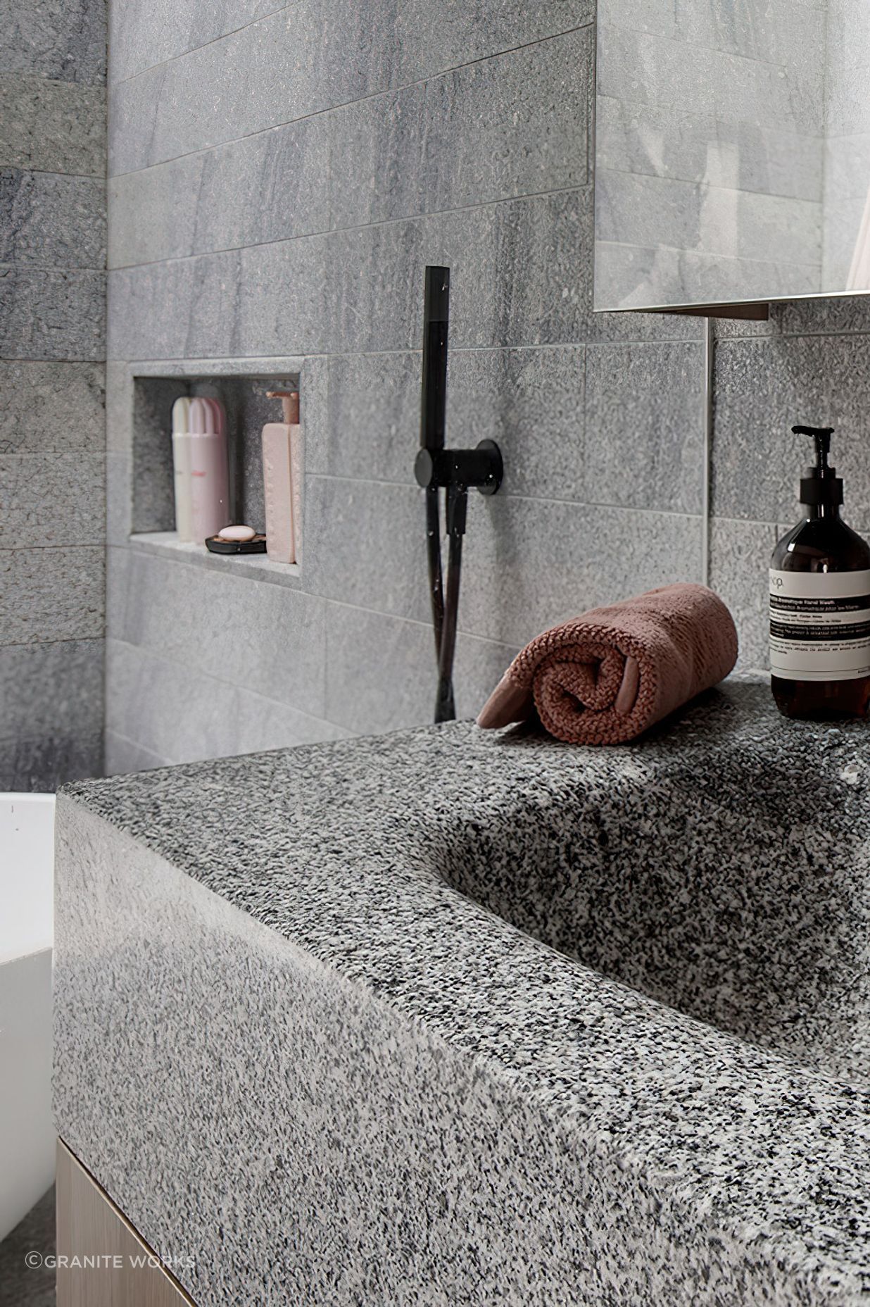 Aston grey granite is used extensively throughout the bathrooms.