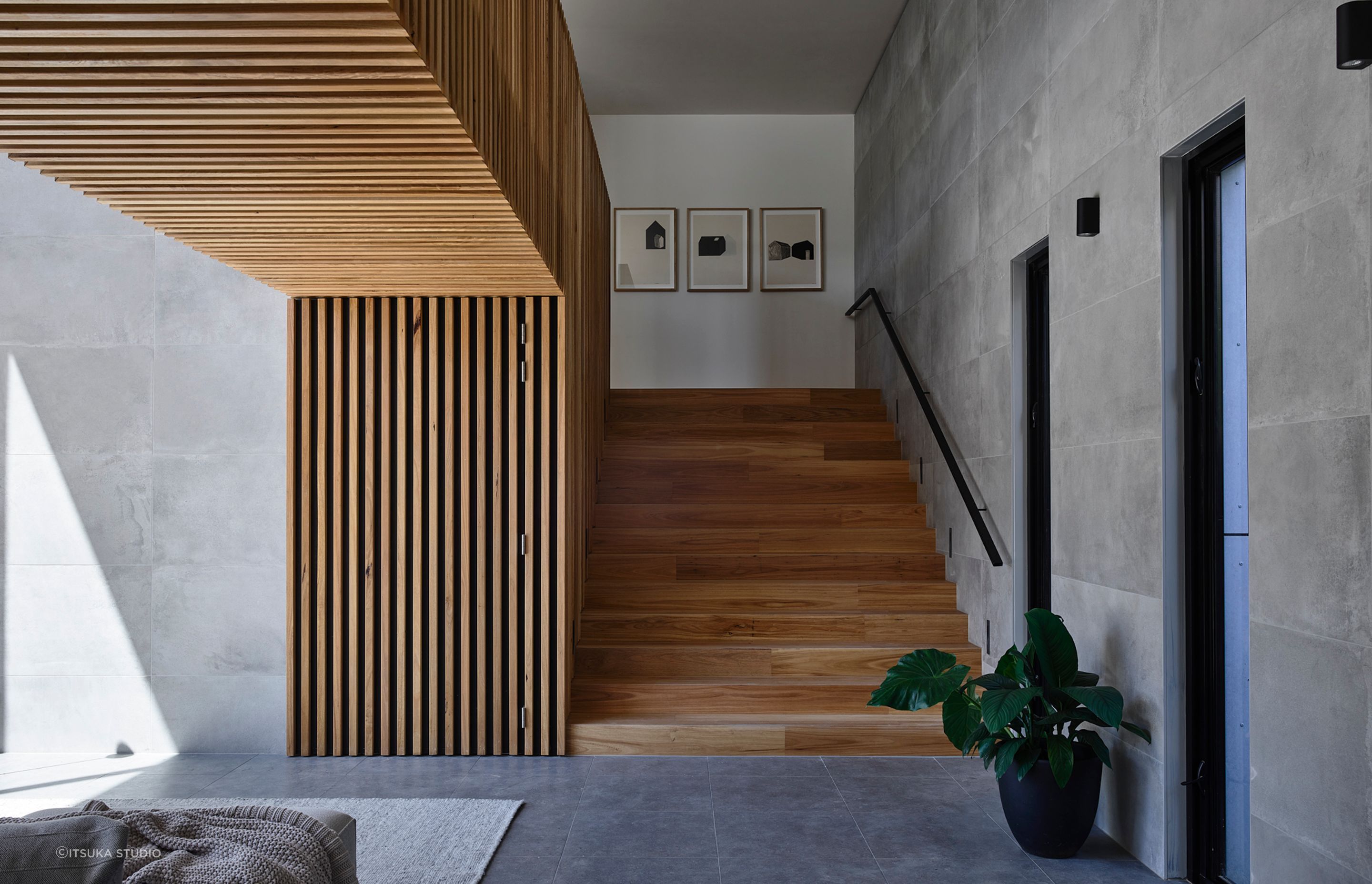 A neutral palette has been used for the home's interior. The wide timber staircase leads to the client's study nook.