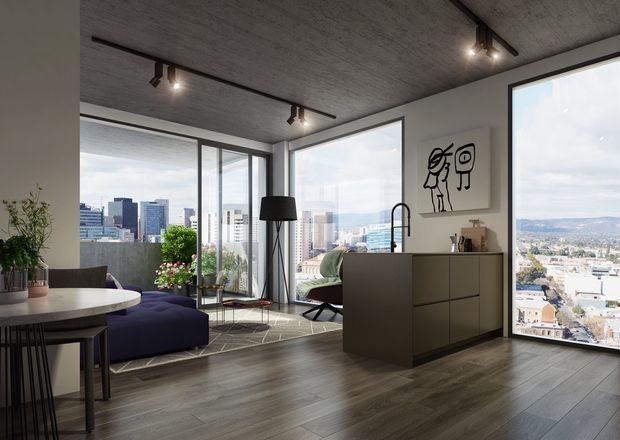 A contemporary open-plan apartment interior with a kitchen, dining area and living room overlooking a dense city skyline through expansive floor-to-ceiling corner glazing. The space features dark wood-look flooring, matte dark cabinetry, a concrete-look ceiling, black track lighting, a purple sectional sofa, and graphic wall art. The room is bright and urban with strong indoor-outdoor visual connection.