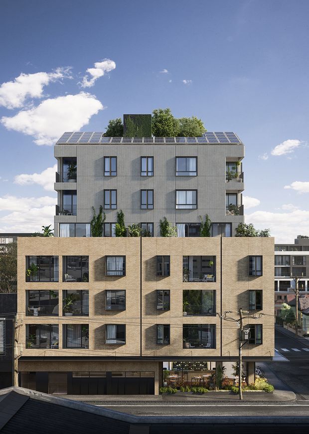 Photorealistic architectural rendering of a multi-storey urban apartment building viewed from across the street. The lower levels feature warm tan brickwork with deeply recessed balconies and windows, while the upper levels use vertically ribbed grey cladding, projecting balconies, and extensive rooftop solar panels. Vegetation is integrated into balconies and the ground-level frontage, with neighbouring urban buildings and streets visible around it.