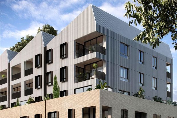 Exterior architectural rendering of a contemporary multi-storey apartment building. The development features a stepped massing, repeated pitched/gabled roof forms, grey vertically ribbed cladding, dark-framed windows, recessed balconies with black metal balustrades, and a lower level clad in pale brick. Landscaping is visible around the building.