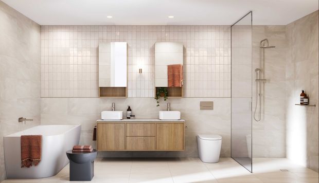 Contemporary bathroom with a freestanding white bathtub, floating timber vanity with twin white vessel basins, mirrored cabinets, wall-mounted toilet, and a frameless glass walk-in shower. Large-format pale stone-look wall tiles are paired with a small square tiled feature wall, creating a warm, refined neutral interior.