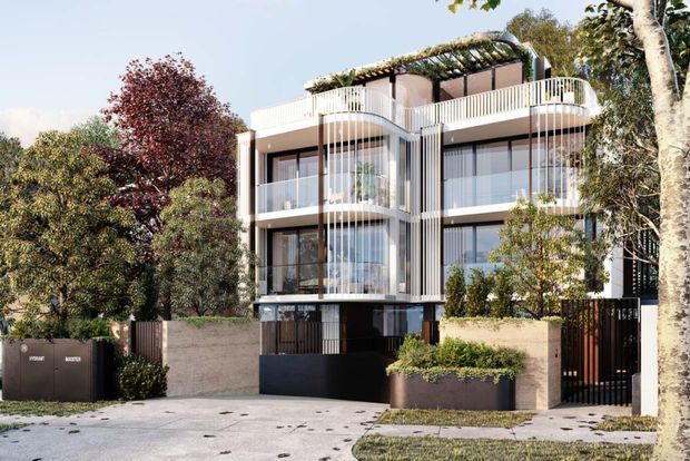 Contemporary multi-storey residential building viewed from the street, featuring curved and linear balcony forms, extensive floor-to-ceiling glazing, pale masonry walls, dark metal elements, vertical screening, and a planted rooftop terrace. Mature trees and landscaped planters frame the facade, with a driveway and gated pedestrian entry at ground level.
