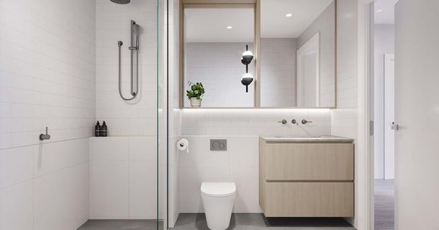 Bright contemporary bathroom with a walk-in glass shower, wall-hung white toilet, floating light-wood vanity, large mirrored cabinet, white tiled walls, and grey floor tiles. An open doorway reveals a bedroom or hallway beyond.