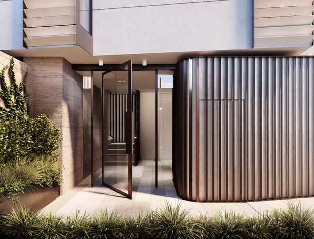 Contemporary residential entrance viewed from an outdoor landscaped approach. The facade combines pale rendered or concrete upper volumes, warm textured masonry, extensive dark-framed glazing, and a distinctive curved vertical ribbed metal screen enclosing the entry zone. Minimal planting with grasses and a green wall softens the architectural composition.