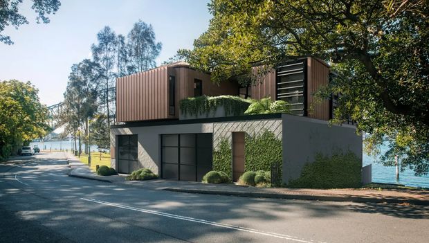 A contemporary multi-level residential building viewed from a tree-lined street beside a body of water. The lower level has a dark garage door, smooth grey rendered walls, and a timber entrance door, while the upper level features vertically ribbed timber-clad volumes, dark horizontal louvres, and a planted terrace with clipped shrubs. Mature trees and waterfront glimpses frame the exterior.