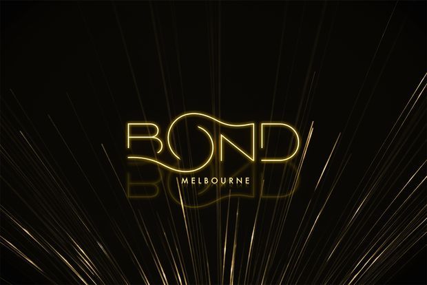 A dark promotional graphic featuring the word “BOND” in glowing gold outlined lettering with “MELBOURNE” beneath it. Fine gold and black radiating lines create a dramatic, high-contrast background with a subtle mirrored reflection below the logo.