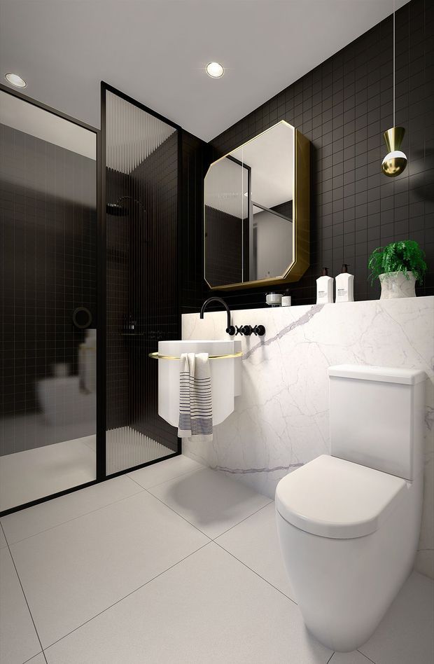 A compact contemporary bathroom with a walk-in shower enclosed by black-framed ribbed glass, dark grid-pattern wall tiles, pale large-format floor tiles, and a wall-hung white toilet. A white marble-look vanity with integrated basin and black tapware sits beneath a faceted illuminated mirror, with a small pendant light and potted plant adding detail.