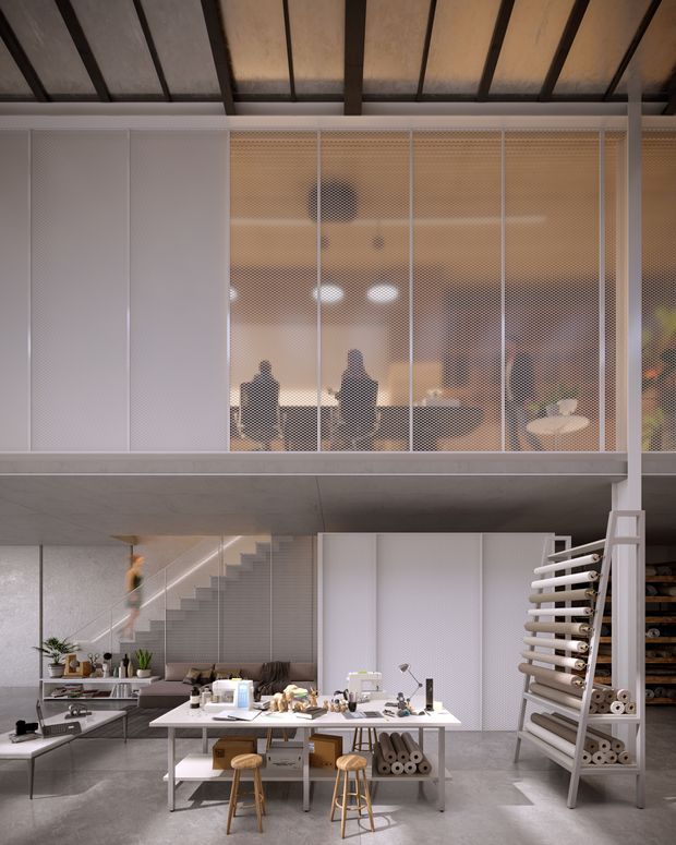 A double-height contemporary studio or workshop interior with a mezzanine level enclosed by translucent perforated screens. The lower level contains a large central worktable with stools, tools and craft materials, open shelving, plants, and a kitchenette or utility area. A sculptural open staircase leads to the upper workspace. Exposed dark structural beams and a concrete floor create an industrial character, while warm translucent screening softens the space.