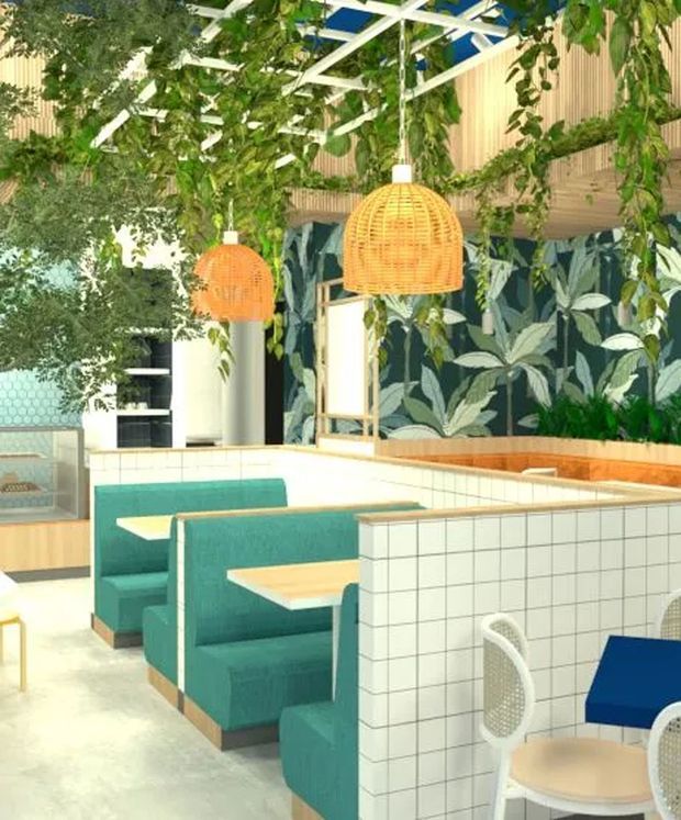 Bright, playful commercial dining interior with turquoise upholstered booth seating, pale timber tables, white tiled low partitions and counters, botanical patterned wall covering, hanging woven pendant lights, and abundant greenery beneath a white pergola-like ceiling structure.