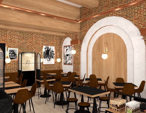 Interior view of a contemporary café or restaurant with exposed red-brick walls, warm timber ceiling and wall panelling, copper service pipes, black-framed tables, and brown upholstered dining chairs. A large arched timber feature doorway or wall opening with white plaster trim dominates the right side, while framed graphic artwork and globe pendant lights add visual interest.