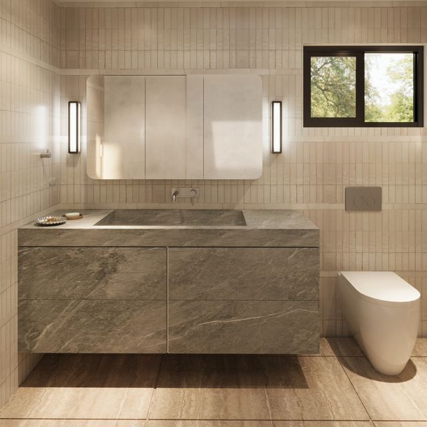 Contemporary bathroom featuring a floating double vanity with dark veined stone cabinetry and benchtop, a large rounded-corner mirrored cabinet, vertical beige wall tiles, matching floor tiles, slim wall sconces, a wall-hung toilet, and a black-framed window overlooking trees.