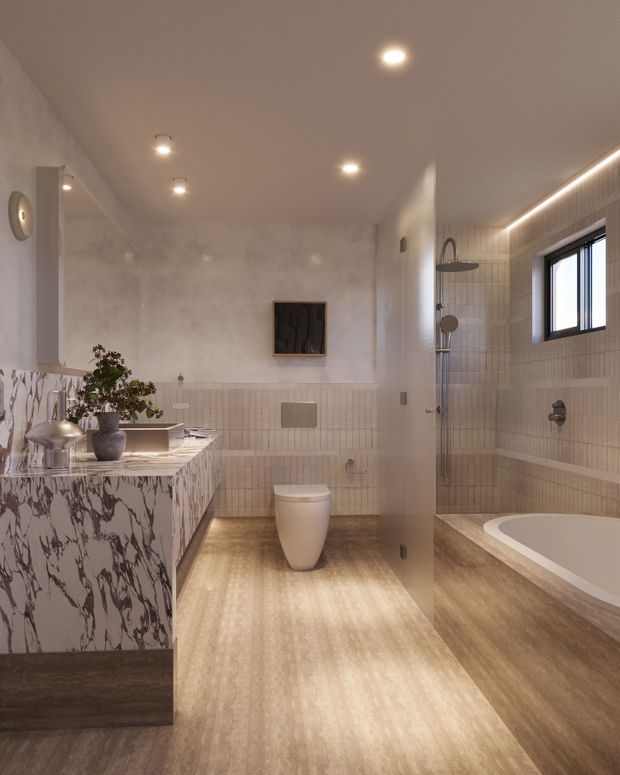 A refined contemporary bathroom with a freestanding toilet, wall-mounted flush plate, glass-enclosed shower, and built-in bathtub. The room features warm beige vertically arranged wall tiles, wood-look flooring and bath surround, a dramatic veined stone vanity, recessed ceiling lighting, and a large black-framed window. A partial-height glass divider separates the toilet and shower zones.