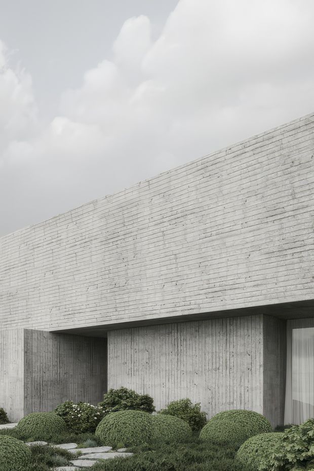 Minimalist contemporary building exterior with a long, monolithic concrete facade and deep recessed openings. The textured grey concrete is paired with carefully clipped rounded shrubs, low planting, and a stepping-stone garden path. Overcast light and restrained monochrome tones create a quiet, sculptural architectural composition.