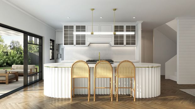 Bright, refined kitchen interior with a large curved island featuring fluted white cabinetry, a pale stone benchtop, white tiled splashback, and white glass-front upper cabinets. Three rattan bar stools line the island. Black-framed sliding glazing opens toward an outdoor area, while a timber herringbone floor and stair zone add warmth. Slim brass pendant lights and brass hardware provide subtle accents.