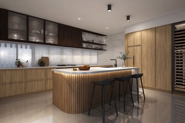 A contemporary kitchen with extensive warm wood cabinetry, dark upper cupboards with ribbed glass fronts, a large curved island with vertical timber detailing and integrated warm LED lighting, and black bar stools. The space includes a pale stone benchtop, integrated appliances, open shelving, under-cabinet glazing with sheer blinds, polished flooring, and a tall wine rack at the right.