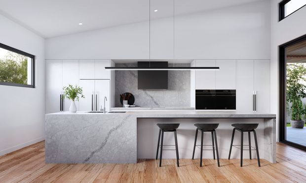 Bright contemporary kitchen with a large white marble-look island and integrated breakfast bar, white full-height cabinetry, matching stone backsplash, black appliances and pendant rangehood, timber flooring, and large windows and glazed doors opening to greenery.