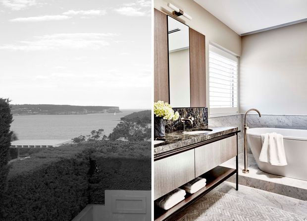Split image showing a refined bathroom interior on the right and a monochrome coastal landscape view on the left. The bathroom features a freestanding white bathtub, marble-look wall and benchtop surfaces, a dark veined stone vanity top, timber-toned vertical joinery, brass tapware, white plantation shutters, and a light herringbone-pattern floor. The coastal image appears as a secondary visual or view associated with the space.