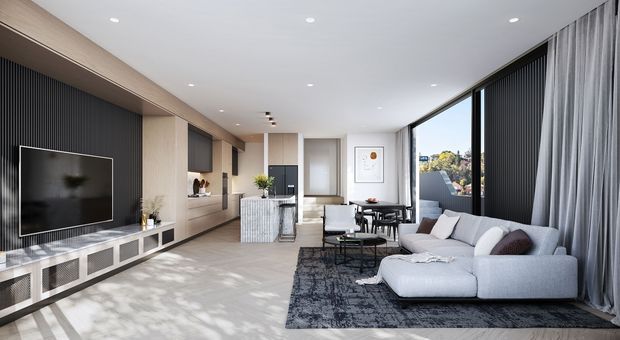 A bright, refined contemporary living room with a large light-grey sectional sofa, dark patterned rug, wall-mounted television, and extensive floor-to-ceiling glazing dressed with full-height curtains. Built-in timber and dark vertical-panel joinery lines the media wall, with a compact dining area and kitchen cabinetry visible toward the rear.