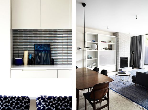 Bright contemporary open-plan living and dining area with a dark timber dining table, black dining chairs, a built-in white media and display wall, tiled fireplace surround, television, dark curtains, and layered neutral rugs. A close-up portion shows the fireplace wall with linear dark tile detailing and decorative objects. The space has strong natural light, clean built-in joinery, and graphic blue-black accents.