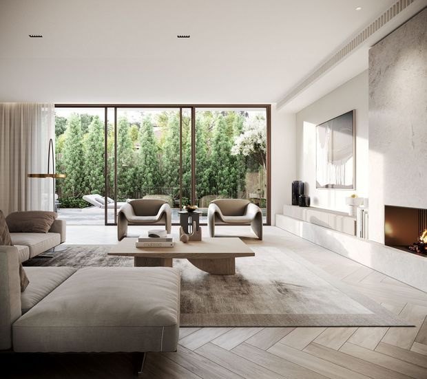 A bright, refined contemporary living room with a large neutral sectional sofa, two sculptural lounge chairs, a low timber coffee table, and a broad textured rug. Full-height glazed doors open toward a leafy private garden, while a long white built-in media wall and a recessed fireplace occupy the right side. Pale timber flooring is laid in a herringbone pattern, with subtle linear ceiling ventilation and minimal artwork.