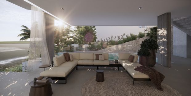 A spacious, open-sided contemporary living room with a large cream L-shaped sectional, woven area rug, timber side tables, sheer curtains, indoor plants, and expansive glazing opening toward a landscaped coastal-looking setting. The room has a flat ceiling with recessed downlights, warm neutral finishes, and a relaxed indoor-outdoor connection.