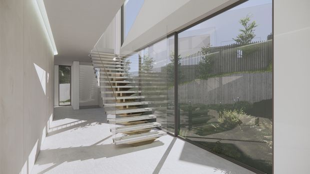 A bright minimalist interior hallway or circulation space featuring a floating open-riser staircase with slim horizontal treads and a glass balustrade. Full-height glazing lines one side, overlooking a small landscaped courtyard, while smooth pale walls, a light floor, and strong natural daylight create a clean contemporary architectural character.