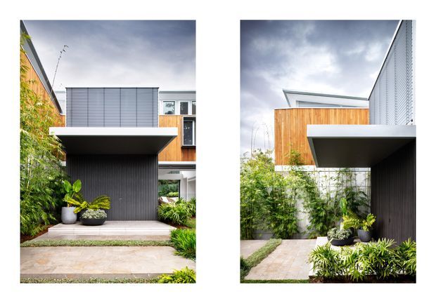 A diptych of two exterior views of a contemporary urban residence. The images show a projecting upper-level volume clad in warm timber, dark vertically ribbed wall surfaces, pale rendered walls, metal screening, and a flat roofline. Landscaped planting and paved paths frame the compact facade and entry/garage-like opening beneath the cantilever.