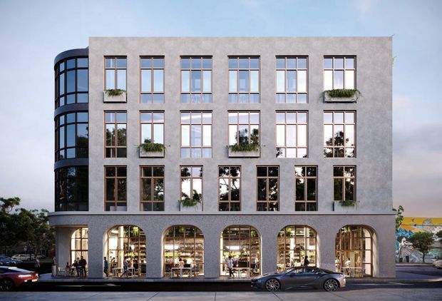 Exterior architectural rendering of a four-storey urban commercial building with a grey rendered facade, regular tall timber-toned framed windows, planted window boxes, a rounded glazed corner stair or circulation volume, and a ground floor of large arched openings containing active retail or hospitality spaces. The building presents a refined contemporary urban frontage.