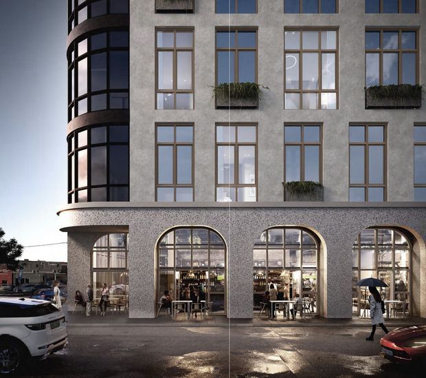 Street-level architectural rendering of a multi-storey urban building with a textured grey facade, tall timber-look framed windows, curved glazed corner bays, and a ground-floor commercial hospitality space behind large arched windows. Planter boxes add greenery to the upper facade, while pedestrians and parked vehicles occupy the street foreground.