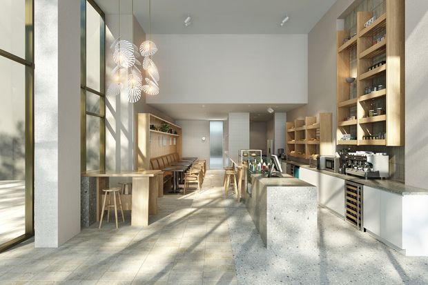 A bright, elongated contemporary commercial café or hospitality interior with a polished concrete floor, tall industrial-style framed glazing, a long service counter and central island, extensive timber shelving and cabinetry, café equipment, and a linear banquette with stools. Decorative pendant lights hang near the glazed frontage, while strong daylight creates a warm, inviting atmosphere.