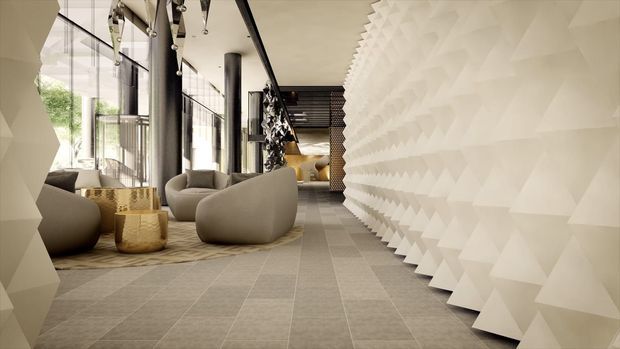 A sophisticated contemporary interior lounge or hotel-style lobby with floor-to-ceiling glazing, sculptural rounded lounge chairs, a warm neutral palette, and a dramatic textured white three-dimensional feature wall along the right side. Large dark structural columns, patterned carpet tiles, decorative pendant lighting, and greenery visible through the glazing contribute to the refined, high-end atmosphere.