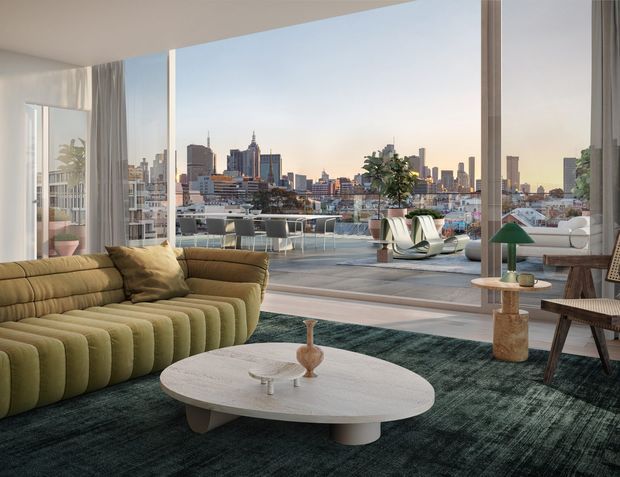 A sophisticated living room with expansive floor-to-ceiling glazing opening onto a large terrace and panoramic urban skyline views. The room features a sculptural olive-green curved sofa, round pale coffee table, dark textured rug, timber occasional furniture, and contemporary decorative lighting. The interior is bright with a refined mid-century-inspired aesthetic, while the terrace and cityscape are clearly visible beyond the glazing.