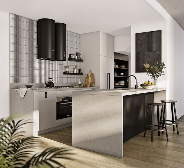 A refined contemporary kitchen with a large stone island, integrated cabinetry, black cylindrical rangehoods, dark stools, and a vertically gridded tiled splashback. The space combines warm timber flooring and neutral stone surfaces with black accents and understated wall art.