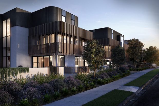 A dusk architectural rendering of a contemporary multi-storey residential development with sculptural dark volumes, pale rendered walls, extensive glazing, and prominent vertical timber-look screening across balconies and facade sections. The building is set along a landscaped suburban streetscape with layered planting, footpaths, and driveways.