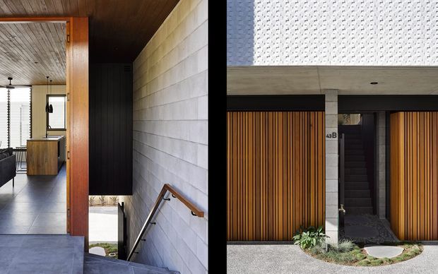 Composite architectural image showing a modern residential entry and stairwell. The interior view features a concrete block wall, dark timber ceiling, timber-framed opening, tiled floor, and a stair descending beside a wood handrail. The exterior view shows a contemporary facade with vertical timber garage or entry doors, pale concrete masonry, a dark recessed entrance, and a textured upper wall surface with restrained landscaping.