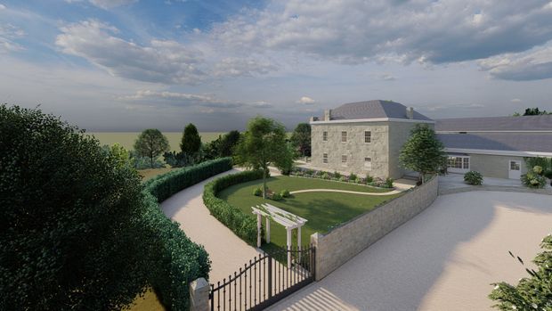 A rendered aerial view of a substantial stone-clad residential property with a hipped roof and attached single-storey wing. The landscaped grounds include clipped hedges, a curved driveway, formal lawn, boundary walls, mature trees, a gated entrance, and a small white pergola. The composition presents the overall estate and building exterior under a partly cloudy sky.