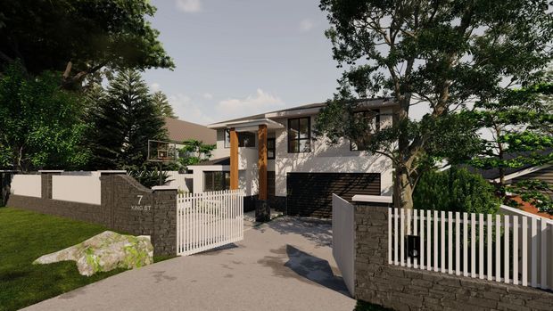 Exterior view of a contemporary multi-level residence with a low-pitched roof, rendered upper walls, dark brickwork at the garage and boundary walls, and a recessed entry. White vertical-slat gates and fencing frame the concrete driveway, with established landscaping and mature trees around the property.