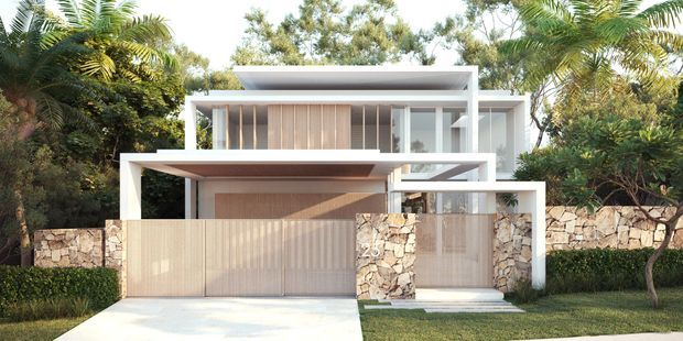 Front exterior view of a contemporary multi-level residence set within lush tropical landscaping. The house features crisp white rectilinear volumes, broad horizontal roof planes, extensive glazing, vertical screening, a pale timber-toned garage and entry gate, and a natural stone boundary wall.