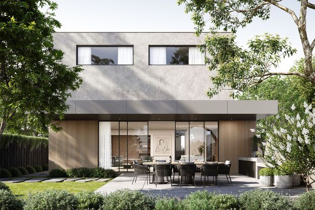 Contemporary two-storey residential house viewed from the landscaped rear garden, featuring a smooth light-grey upper facade, broad projecting canopy, large glazed ground-floor openings, vertical timber screening, and an outdoor dining terrace. Mature planting and clipped hedges frame the home.