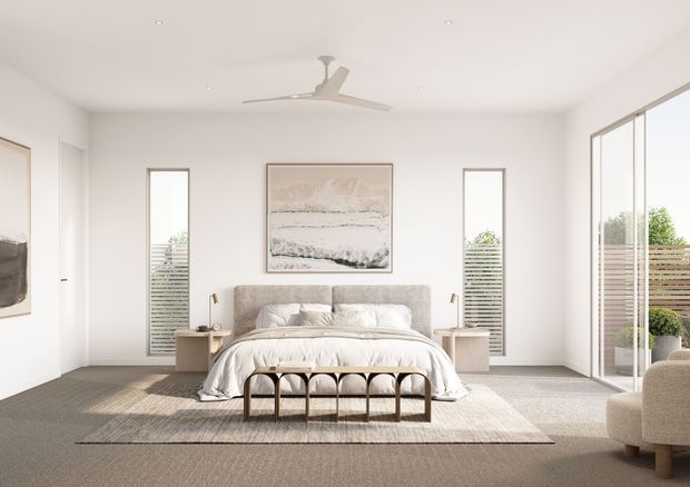 Bright, spacious contemporary bedroom with a centered upholstered bed, neutral bedding, slim bedside tables, and a black metal foot bench. White walls and ceiling, broad carpeted flooring, sheer floor-to-ceiling glazing on the right, narrow windows behind the bed, a ceiling fan, and understated abstract artwork create a calm, light-filled interior.