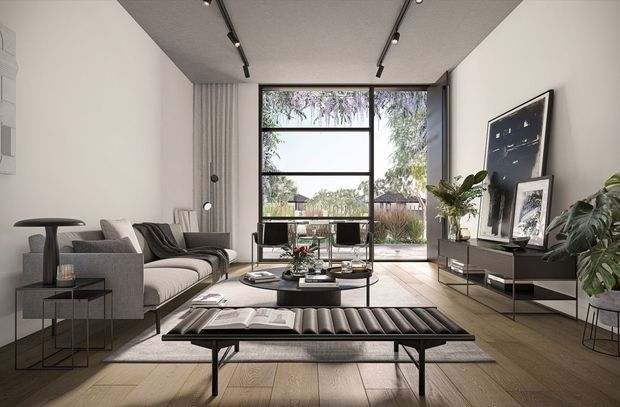 A refined contemporary living room with a grey sectional sofa, sculptural coffee table, black leather slatted bench, slim dark media console, and large framed artwork. Full-height glazing opens to a landscaped exterior, while linear track lighting and pale timber flooring create a bright, spacious setting.