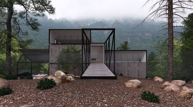 A compact contemporary house set within a rocky, forested mountain landscape. The dark-framed structure combines glass walls, weathered vertical timber cladding, low horizontal wings and a raised central entrance approached by a broad ramp. Misty mountains are visible beyond the building, while native planting, exposed rocks and gravel form the foreground landscape.