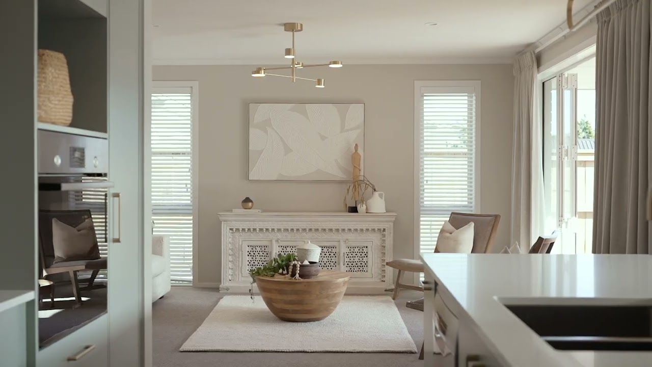 11b Western Ave, Omokoroa. Step inside and be greeted by a spacious open-plan living area, ideal for both entertaining and everyday comfort. The contemporary kitchen is a true standout, featuring brass fixtures that add a touch of sophistication, compleme