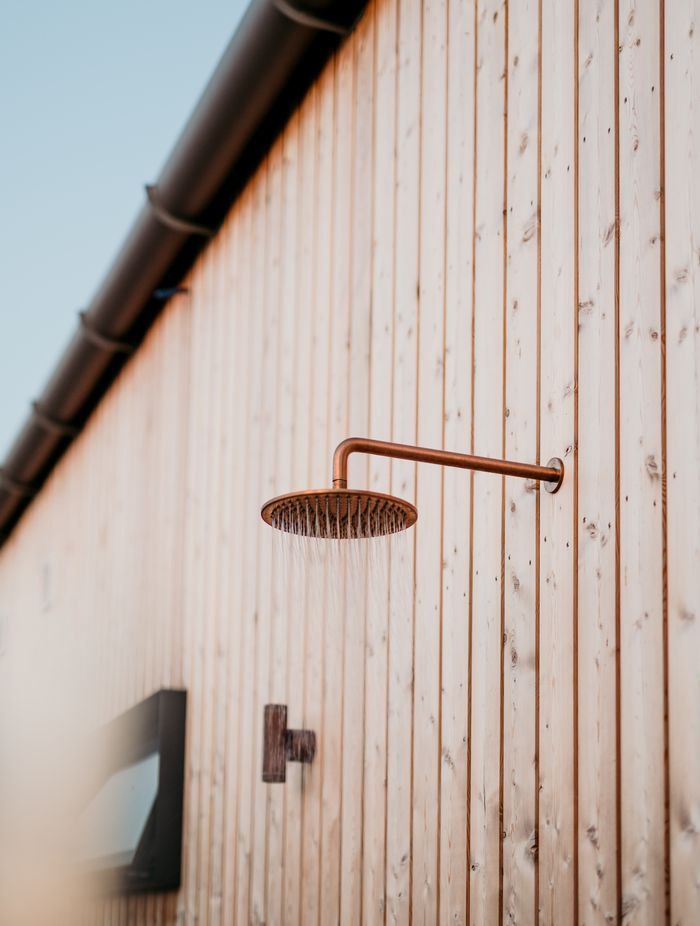 Siberian larch timber cladding, fixed with over 4000 hand-driven copper nails surrounds the residence.
