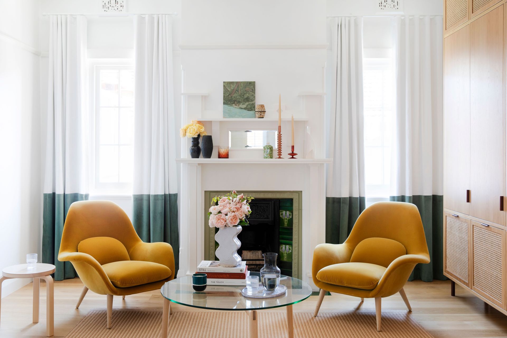 Dual-toned curtains playfully align with the ornate sills of the original windows.