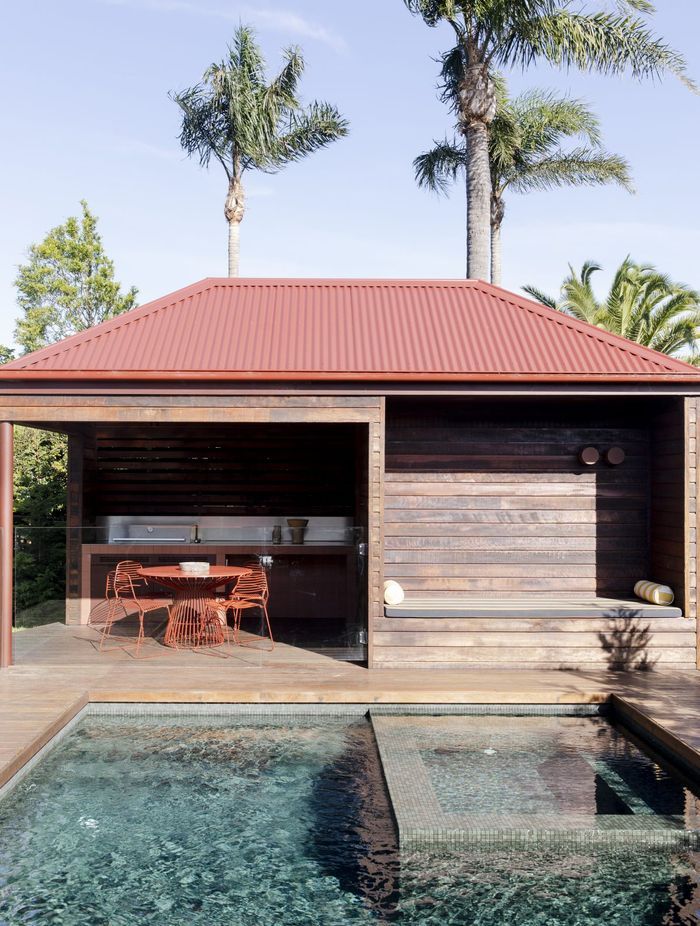 An outdoor entertainment space draws one toward cooling waters.