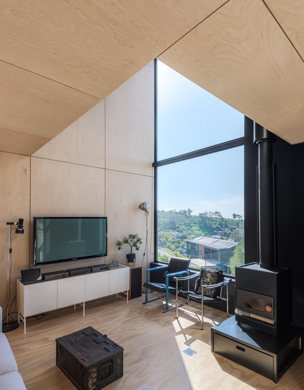 Meticulously lined up plywood panels frame the interior walls and ceiling.
